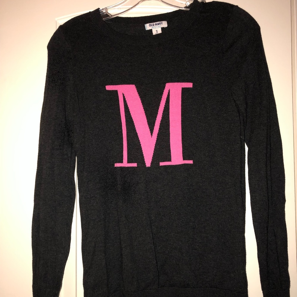 Dark grey sweater with pink “M”